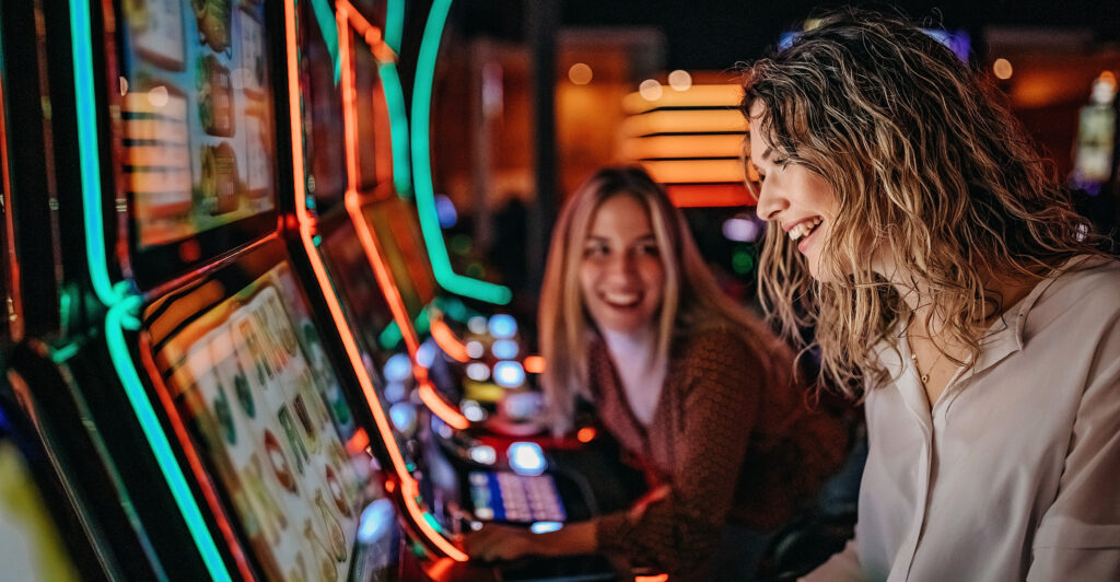 Two woman playing slot machines at Gold Country Casino in Northern California.