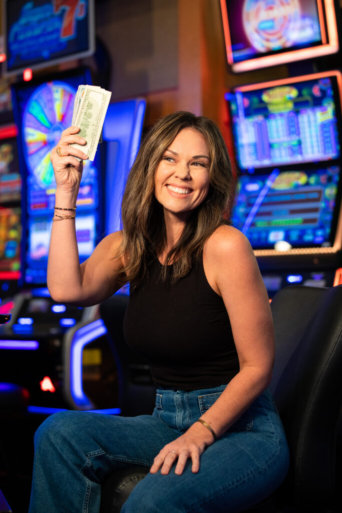 Woman holding up cash at Gold Country Casino in Oroville, Northern California.